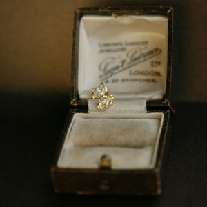 Diamond earrings displayed on a vintage jewellery box
